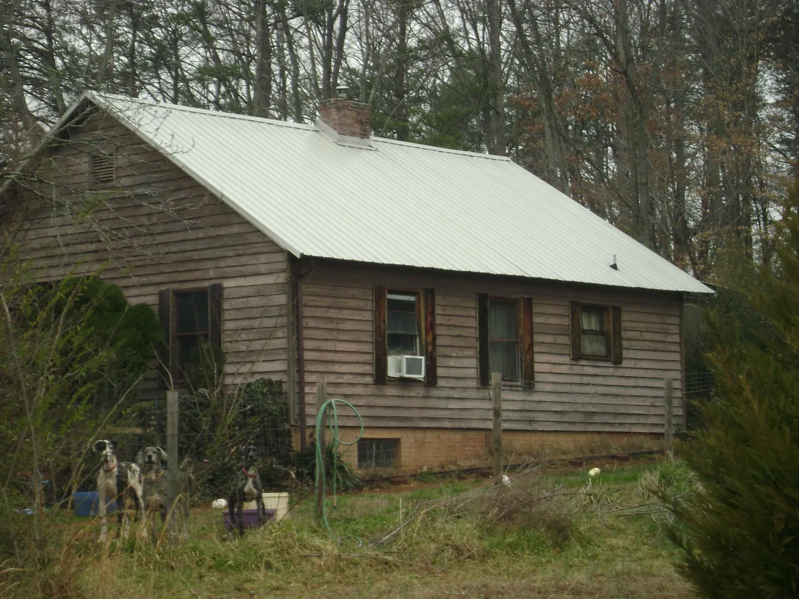White metal roof on an old wood sided farmhouse, from a Metal Roof Installation job in Davis